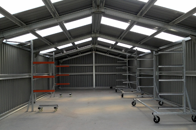 Adjustable Swift boat racks installed in a boathouse