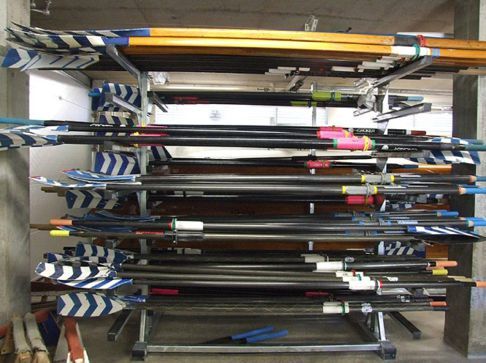 Swift horizontal oar rack loaded with scull and sweep oars laid flat