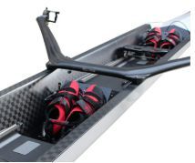 Carbon Reverse Wing rigger, black carbon with red oarlocks, mounted behind the rower